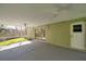Inviting screened porch area with a ceiling fan and access to the yard at 4932 Wellbrook Dr, New Port Richey, FL 34653