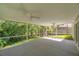 Large screened porch with open views of the lush, green surroundings at 4932 Wellbrook Dr, New Port Richey, FL 34653