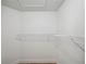 White walk-in closet with wire shelving and wood floors at 4932 Wellbrook Dr, New Port Richey, FL 34653