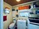 Small laundry bathroom with washing machine, toilet, mirror, and cabinet sink at 4976 12Th N Ave, St Petersburg, FL 33710