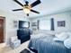 Comfortable bedroom featuring a ceiling fan and window with blinds, and dresser with shelves at 4976 12Th N Ave, St Petersburg, FL 33710