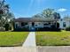 Charming single-story home with a well-manicured lawn and inviting walkway, perfect for a cozy living at 4976 12Th N Ave, St Petersburg, FL 33710