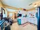 Bright kitchen featuring white cabinets, laminate countertops, with an adjoining living area at 4976 12Th N Ave, St Petersburg, FL 33710
