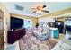 Comfortable living room featuring a ceiling fan, a recliner chair, and an ornate area rug at 4976 12Th N Ave, St Petersburg, FL 33710