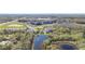 A gorgeous aerial view of a community situated by lakes and lush greenery; near shopping centers at 5016 Bella Armonia Cir, Wimauma, FL 33598