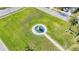 Aerial view of a community fountain situated in a meticulously landscaped green space at 5016 Bella Armonia Cir, Wimauma, FL 33598