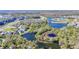 Stunning aerial view of a neighborhood with beautiful lakes and landscaping, near a golf course at 5016 Bella Armonia Cir, Wimauma, FL 33598