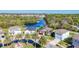 Aerial view of homes and community with mature trees and a lake at 5016 Bella Armonia Cir, Wimauma, FL 33598