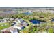 An aerial shot showcases a home surrounded by serene lakes and lush landscapes in a residential area at 5016 Bella Armonia Cir, Wimauma, FL 33598