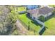 Aerial view of a fenced backyard featuring well-maintained grass and landscaping at 5016 Bella Armonia Cir, Wimauma, FL 33598