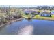 Charming home with a fenced yard overlooking a tranquil pond surrounded by lush greenery at 5016 Bella Armonia Cir, Wimauma, FL 33598