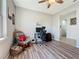 Home office space with a computer desk, an accent chair, and wood laminated floors at 5016 Bella Armonia Cir, Wimauma, FL 33598