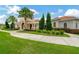Well-maintained clubhouse featuring manicured landscaping, stone accents, and tile roof at 5016 Bella Armonia Cir, Wimauma, FL 33598