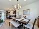 Open concept dining and kitchen area with granite countertops, stainless appliances, and seating for six at 5016 Bella Armonia Cir, Wimauma, FL 33598