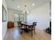 Well-lit dining room with tile floors and elegant chandelier above the table at 5016 Bella Armonia Cir, Wimauma, FL 33598