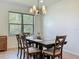 Well-lit dining room with tile floors and chandelier above the table at 5016 Bella Armonia Cir, Wimauma, FL 33598