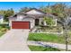Inviting single-Gathering home with a well-kept lawn, landscaped flowerbeds, and a two-car garage at 5016 Bella Armonia Cir, Wimauma, FL 33598