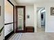 Foyer with decorative door leading to a laundry room and tiled flooring at 5016 Bella Armonia Cir, Wimauma, FL 33598