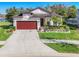 Charming single-story home with well-manicured landscaping and a two-car garage at 5016 Bella Armonia Cir, Wimauma, FL 33598