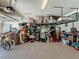 Spacious garage with overhead storage racks, shelving and epoxy flooring provides ample space for storage at 5016 Bella Armonia Cir, Wimauma, FL 33598