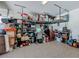Organized garage space featuring overhead storage racks, shelving and ample room for vehicles at 5016 Bella Armonia Cir, Wimauma, FL 33598