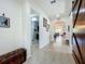 Bright hallway with tile floors and a decorative barn door feature at 5016 Bella Armonia Cir, Wimauma, FL 33598