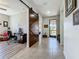 Hallway with a large barn door separating the living area from the hallway at 5016 Bella Armonia Cir, Wimauma, FL 33598