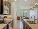 Eat-in kitchen with granite counters, dark wood cabinetry, island seating, and stainless appliances at 5016 Bella Armonia Cir, Wimauma, FL 33598