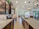 Bright kitchen with granite counters, stainless appliances, dark wood cabinets, and island with sink at 5016 Bella Armonia Cir, Wimauma, FL 33598
