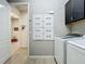 Bright laundry room featuring a modern washer and dryer and convenient storage cabinets at 5016 Bella Armonia Cir, Wimauma, FL 33598
