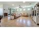Bright living room with tile floors, ceiling fan, comfortable sofas, and sliding glass doors to screened patio at 5016 Bella Armonia Cir, Wimauma, FL 33598