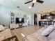 Open-concept living room with tile floors and neutral walls, flowing into a modern kitchen with dark cabinets at 5016 Bella Armonia Cir, Wimauma, FL 33598