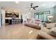 Open concept living room and kitchen with breakfast bar, pendant lighting, and sliding glass door to patio at 5016 Bella Armonia Cir, Wimauma, FL 33598