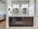 Stylish bathroom featuring granite counters, dark cabinetry, double sinks, and modern fixtures for a luxurious feel at 5016 Bella Armonia Cir, Wimauma, FL 33598