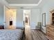 Bright main bedroom with wood flooring and two walk-in closets at 5016 Bella Armonia Cir, Wimauma, FL 33598