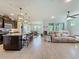 Spacious open-concept layout connecting the kitchen, dining area, and living room for a seamless flow at 5016 Bella Armonia Cir, Wimauma, FL 33598