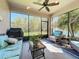Relaxing screened-in patio with comfortable seating and a view of the lush backyard at 5016 Bella Armonia Cir, Wimauma, FL 33598