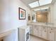 Bathroom with large mirror, vanity with storage, and shower with sliding glass doors at 5220 Brittany S Dr # 1108, St Petersburg, FL 33715