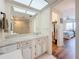 Bright bathroom featuring a vanity with cabinets, mirror, and an adjacent bedroom and closet at 5220 Brittany S Dr # 1108, St Petersburg, FL 33715