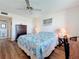Bright bedroom features wood floors, ceiling fan, and coastal-themed decor at 5220 Brittany S Dr # 1108, St Petersburg, FL 33715
