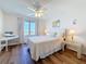 Inviting bedroom with wood floors, ceiling fan, waterfront views, and a writing desk at 5220 Brittany S Dr # 1108, St Petersburg, FL 33715