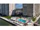 Resort-style condo featuring a pristine pool area, lounge chairs, and waterfront views at 5220 Brittany S Dr # 1108, St Petersburg, FL 33715