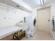 Bright laundry room with white washer, dryer, utility sink and folding table, perfect for easy chore days at 5220 Brittany S Dr # 1108, St Petersburg, FL 33715