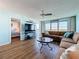 Bright living room with expansive windows offering views, a cozy brown sectional, and tv at 5220 Brittany S Dr # 1108, St Petersburg, FL 33715