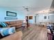 Comfortable living room featuring a brown sectional sofa, ceiling fan, and wood-look flooring at 5220 Brittany S Dr # 1108, St Petersburg, FL 33715