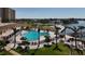 Community pool area with surrounding lounge chairs and lush tropical landscaping at 5220 Brittany S Dr # 1108, St Petersburg, FL 33715