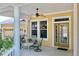 Charming front porch with comfortable seating, offering a welcoming entryway to the home at 5709 Sea Turtle Pl, Apollo Beach, FL 33572