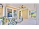 Inviting front porch featuring comfortable seating and a ceiling fan for relaxing outdoors at 5709 Sea Turtle Pl, Apollo Beach, FL 33572