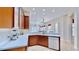 Open kitchen with wood cabinets, white countertops, and seamless flow into the living area at 5709 Sea Turtle Pl, Apollo Beach, FL 33572