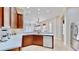 Open concept kitchen with white countertops, wood cabinets, and a stainless steel refrigerator at 5709 Sea Turtle Pl, Apollo Beach, FL 33572
